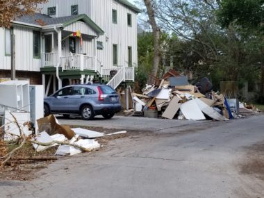 Debris piled outside homes illustrates the extent of the destruction the relief team encountered on their previous trips to the area.