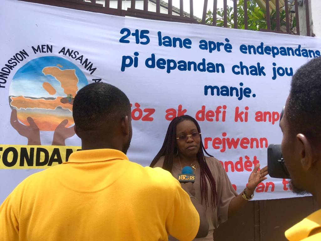 Fabienne Jean, coordinator of FONDAMA, Hands Together Foundation of Haiti, speaks to the media about the need for solutions to Haiti’s poverty in June 2018. Photo by Cindy Corell.