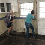 Once the kitchen is cleared of cabinets, Jeff and Betty Williams mark where to remove water-damaged drywall