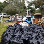 Debris removed from a home fills its yard